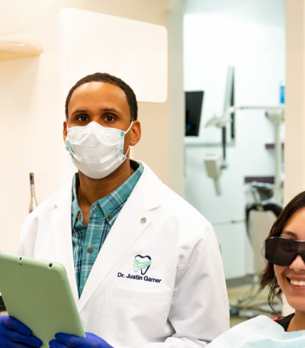 Doctor Justin Garner wearing a face mask and a white lab coat