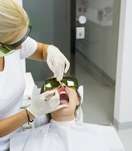 Dental patient having their gums treated with a soft tissue laser