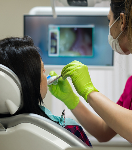 Dentist taking close up photos of a patients teeth on a screen in real time