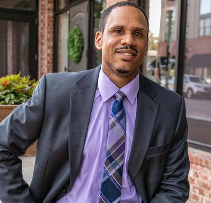 Independence dentist Doctor Justin Garner smiling in a suit