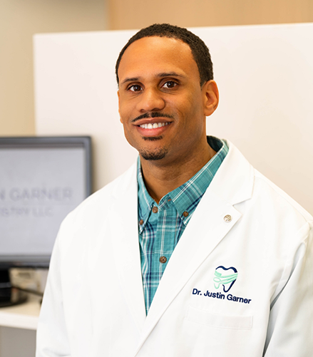 Doctor Garner smiling in a white lab coat