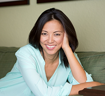 Smiling woman in mint green blouse