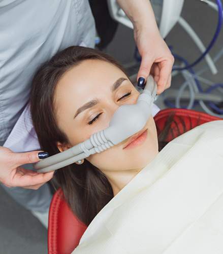 Dental patient with a nitrous oxide mask over her nose